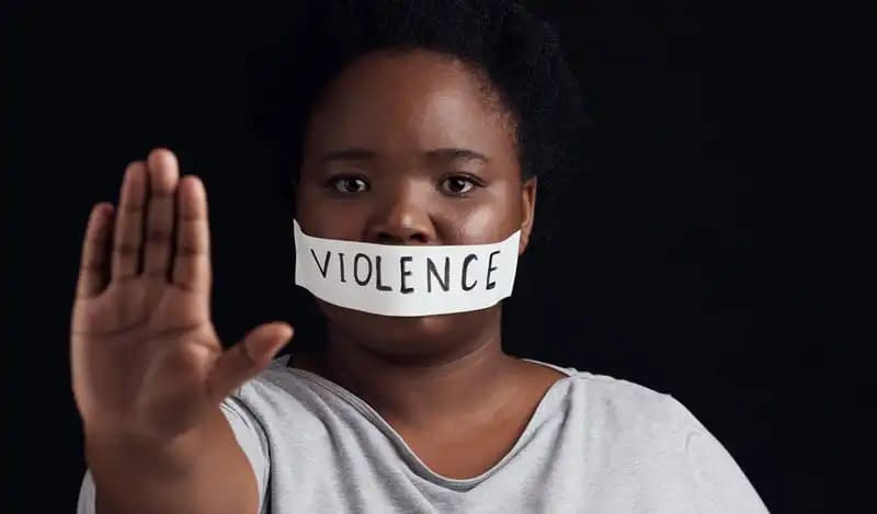 black woman in protest of domestic violence on a dark background